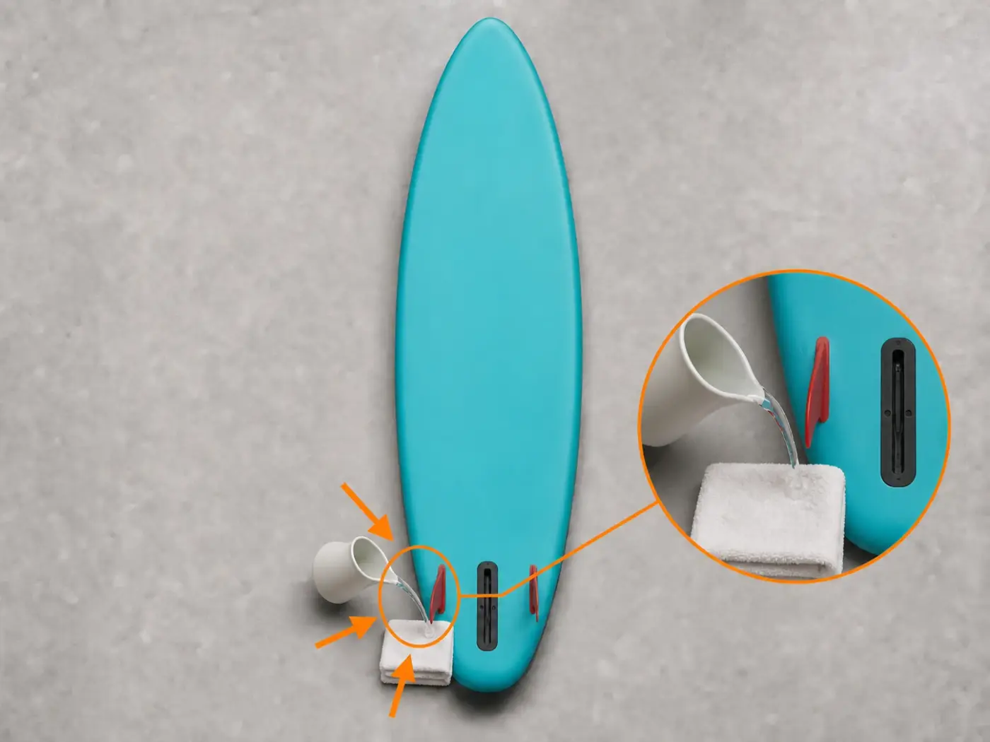 Água quente aplicada de forma controlada à quilha vermelha sobre uma toalha e longe do resto do SUP
